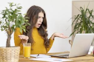 Female angering and annoying, surprised broken Internet line. Young woman student photo