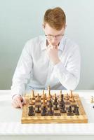 Quarantine, self-isolation. Home games, Smart guy is playing chess photo