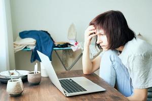 Digital addiction, woman in panic reads articles about coronavirus on Internet photo