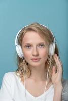 Closeup vertical portrait of young woman closed eyes listening music photo