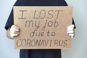 Job loss due to COVID-19 virus pandemic concept. Unrecognizable person holds sign I lost my job photo