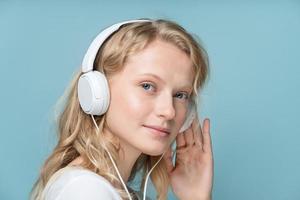 Closeup portrait of side view young woman closed eyes listening music photo