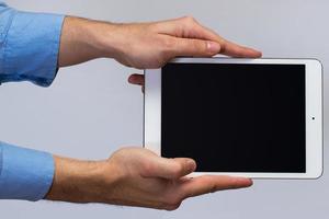 White tablet pc in hands photo