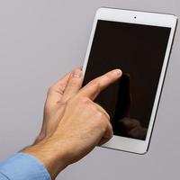 White tablet pc in hands photo