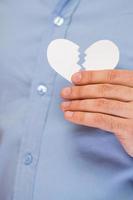 Hand with broken paper heart photo