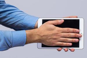 White tablet pc in hands photo