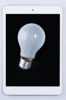 Light bulb and tablet pc photo