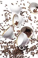 Falling coffee cups and beans photo