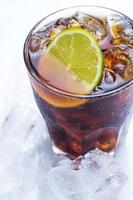 Fresh cocktail with cola drink and lime photo