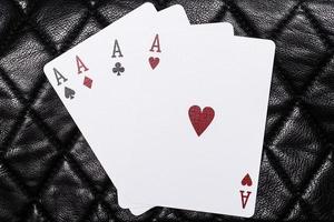 Four Aces on leather background photo