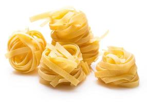 Uncooked pasta on white background photo