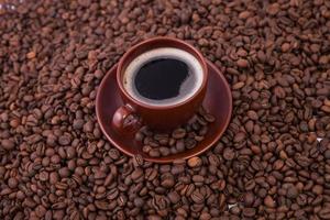 Cup of coffee on the coffee beans background photo