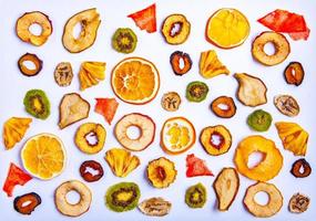 Organic Healthy Assorted Dried Fruit Mix close up. Dried fruit snacks. dried apples, mango, feijoa, dried apricots, prunes top view photo