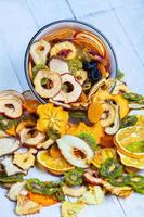 Organic Healthy Assorted Dried Fruit Mix close up. Dried fruit snacks. dried apples, mango, feijoa, dried apricots, prunes top view photo