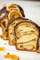 Home Made Panettone. Traditional Italian sweet bread. Panettone with a slice served on a wooden table.