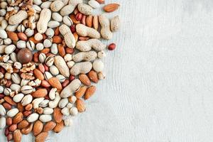 Assorted nuts for a background Almond, walnut,cashew, pistachios, hazelnuts, peanuts, Macadamia Collection of different varieties of nuts. Composition with dried fruits Healthy food. Organic. photo