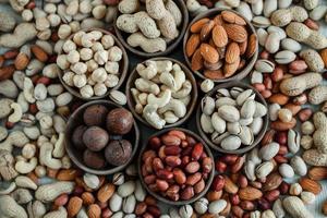 Assorted nuts for a background Almond, walnut,cashew, pistachios, hazelnuts, peanuts, Macadamia Collection of different varieties of nuts. Composition with dried fruits Healthy food. Organic. photo