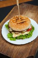 Top view hamburger on the wooden background . Hamburger, homemade hamburger with fresh vegetables.Beef burger. photo