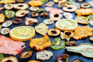 Organic Healthy Assorted Dried Fruit Mix close up. Dried fruit snacks. dried apples, mango, feijoa, dried apricots, prunes top view photo