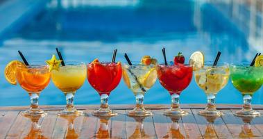 Various alcoholic cocktails on white background. Colorful cocktails close up. Fruit juice cocktail drink. assorted cocktail drinks. Glasses of fruit drinks with ice cubes on table in cafe photo