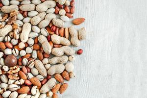 Assorted nuts for a background Almond, walnut,cashew, pistachios, hazelnuts, peanuts, Macadamia Collection of different varieties of nuts. Composition with dried fruits Healthy food. Organic. photo