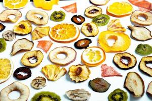 Organic Healthy Assorted Dried Fruit Mix close up. Dried fruit snacks. dried apples, mango, feijoa, dried apricots, prunes top view photo