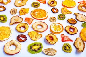 Organic Healthy Assorted Dried Fruit Mix close up. Dried fruit snacks. dried apples, mango, feijoa, dried apricots, prunes top view photo