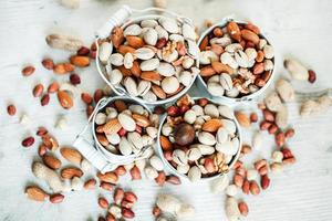 Assorted nuts for a background Almond, walnut,cashew, pistachios, hazelnuts, peanuts, Macadamia Collection of different varieties of nuts. Composition with dried fruits Healthy food. Organic. photo