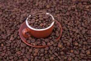 Cup of coffee on the coffee beans background photo