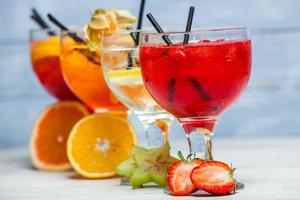 Various alcoholic cocktails on white background. Colorful cocktails close up. Fruit juice cocktail drink. assorted cocktail drinks. Glasses of fruit drinks with ice cubes on table in cafe photo