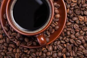 Cup of coffee on the coffee beans background photo