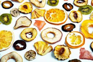 Organic Healthy Assorted Dried Fruit Mix close up. Dried fruit snacks. dried apples, mango, feijoa, dried apricots, prunes top view photo