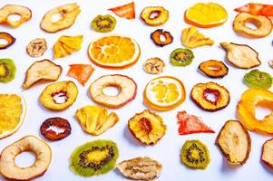 Organic Healthy Assorted Dried Fruit Mix close up. Dried fruit snacks. dried apples, mango, feijoa, dried apricots, prunes top view photo