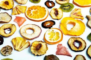 Organic Healthy Assorted Dried Fruit Mix close up. Dried fruit snacks. dried apples, mango, feijoa, dried apricots, prunes top view photo