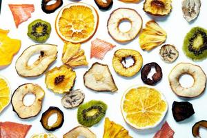 Organic Healthy Assorted Dried Fruit Mix close up. Dried fruit snacks. dried apples, mango, feijoa, dried apricots, prunes top view photo