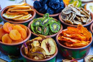 Organic Healthy Assorted Dried Fruit Mix close up. Dried fruit snacks. dried apples, mango, feijoa, dried apricots, prunes top view photo