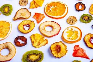 Organic Healthy Assorted Dried Fruit Mix close up. Dried fruit snacks. dried apples, mango, feijoa, dried apricots, prunes top view photo