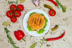 Top view hamburger on the wooden background . Hamburger, homemade hamburger with fresh vegetables.Beef burger. photo