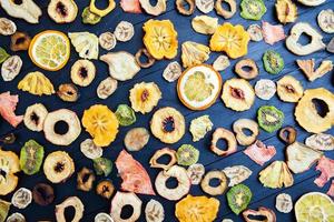 Organic Healthy Assorted Dried Fruit Mix close up. Dried fruit snacks. dried apples, mango, feijoa, dried apricots, prunes top view photo