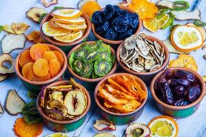 Organic Healthy Assorted Dried Fruit Mix close up. Dried fruit snacks. dried apples, mango, feijoa, dried apricots, prunes top view photo