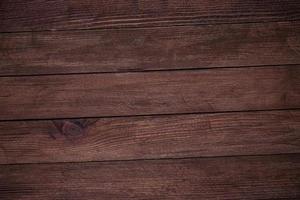 Vintage brown wood background texture with knots and nail holes. Old painted wood wall. Brown abstract background. Vintage wooden dark horizontal boards. Front view with copy space. photo