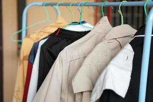 Multi-colored t-shirts on a hanger. Clothing store. photo