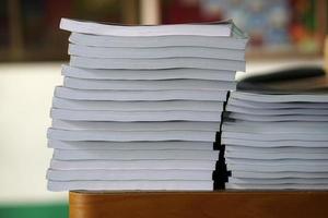 Book stack on wood desk photo