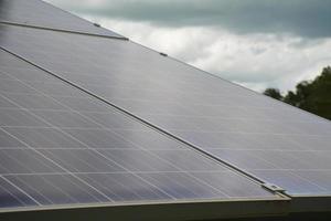 selective focus.Solar panels on the roof of a tropical city house early in the morning photo