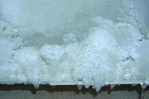 The ice sticks together in the refrigerator compartment. photo