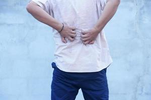 Backside of white man back pain and ache concept,Itchy Asian man in the back photo