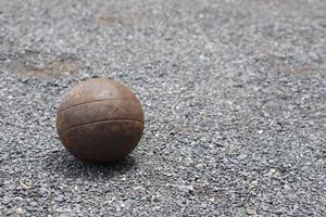 Petanque boules on a field with small stones photo