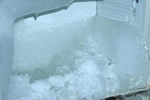 The ice sticks together in the refrigerator compartment. photo