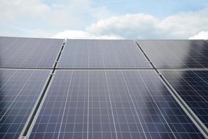 selective focus.Solar panels on the roof of a tropical city house early in the morning photo