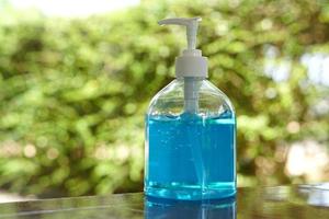 man washing his hands with algohol gel to disinfection of covid -19 and other bacteria photo